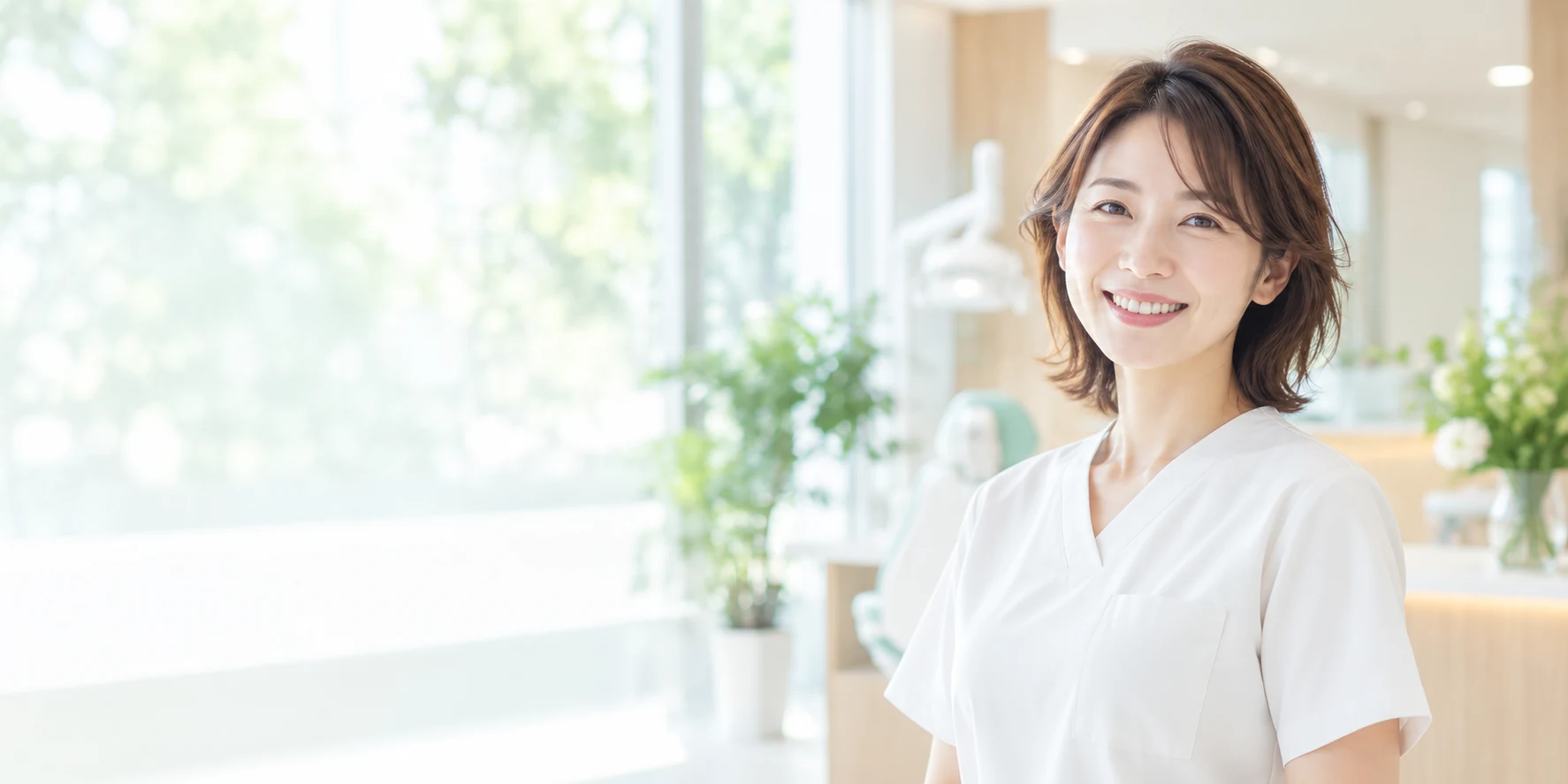 明るい歯科医院で笑顔の歯科医師